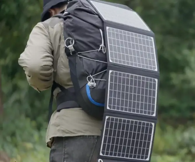 Person with a portable solar panel charger on their back