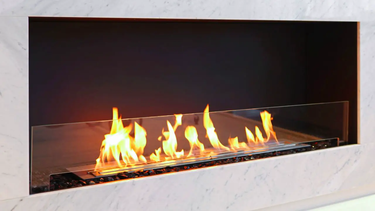 Photo of a large bio ethanol fireplace in a white marble surround